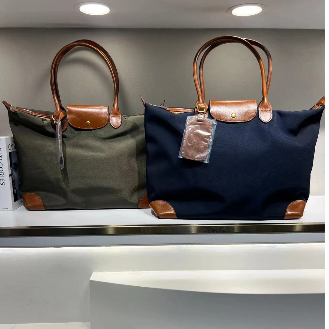 2025莎堡新款大容量防水布料配头层牛皮单肩女包40：15：32